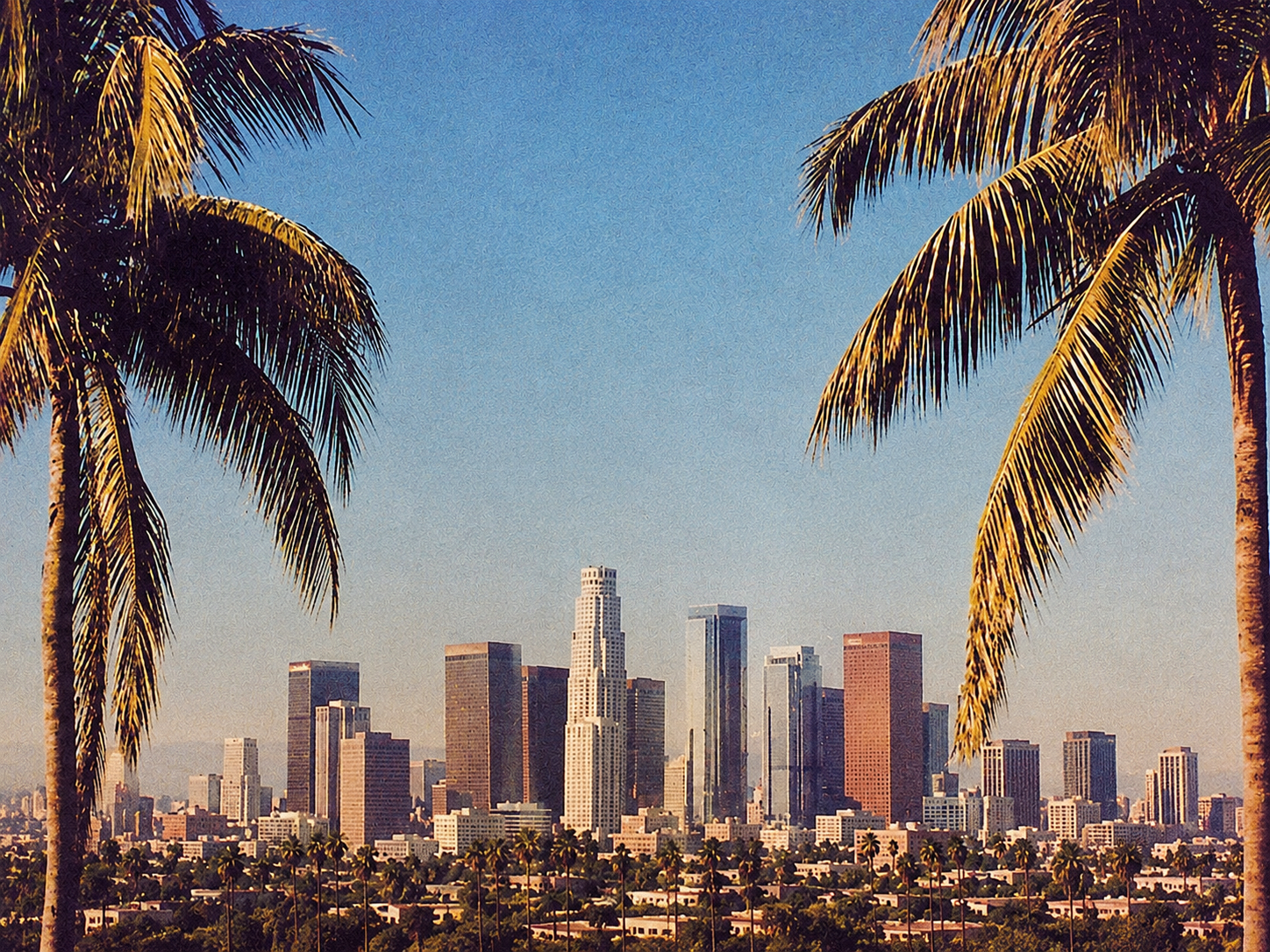 Downtown Los Angeles framed by palm trees