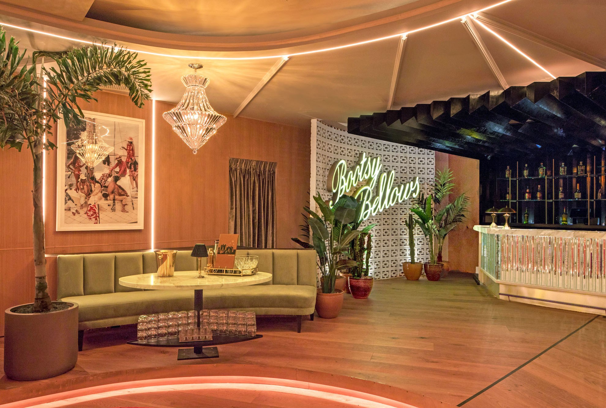 The reopened Bootsy Bellows interior with pastel seating, plants, and a mirrored bar.